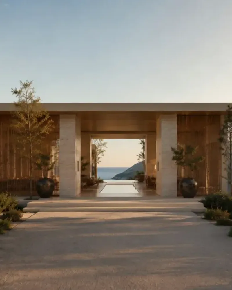 A travertine house among silver olive and cypress, the bay framed in its open doorway at golden hour.