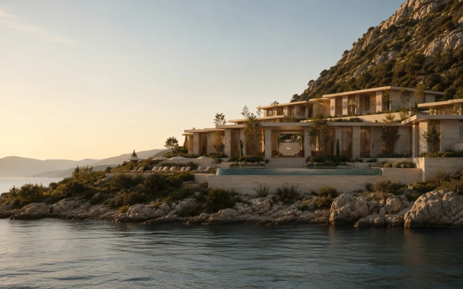 The travertine terraces of ALMARÉ above the bay at golden hour, the sun low over the sea.